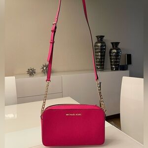 Brand New Micheal Kors crossbody purse color raspberry